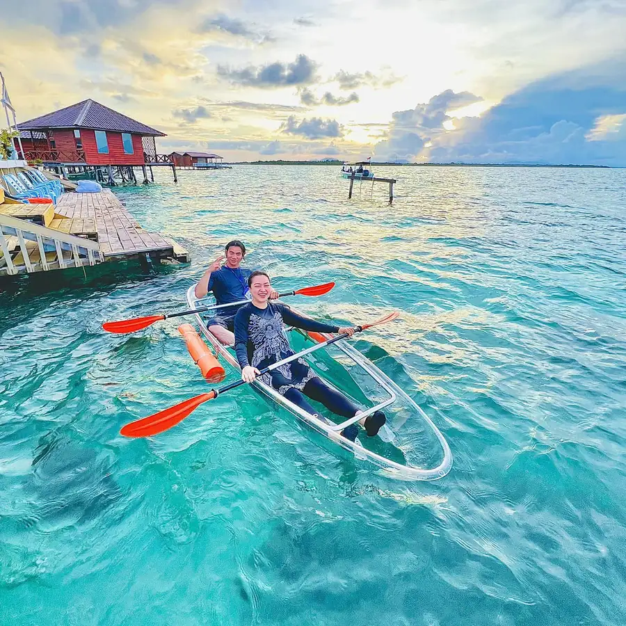 Guest enjoying a kayaking session in the turquoise sea Sky Water Villas