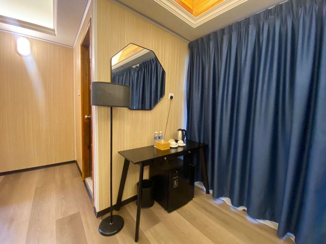 Sunset Villa bedroom with desk and mini-fridge
